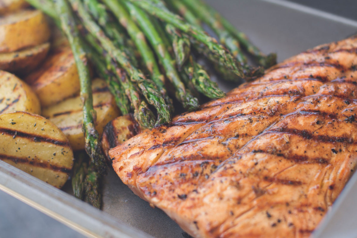 Grilled salmon glazed with CharBoy's Bourbon-Teriyaki Sauce, served with grilled potatoes and asparagus