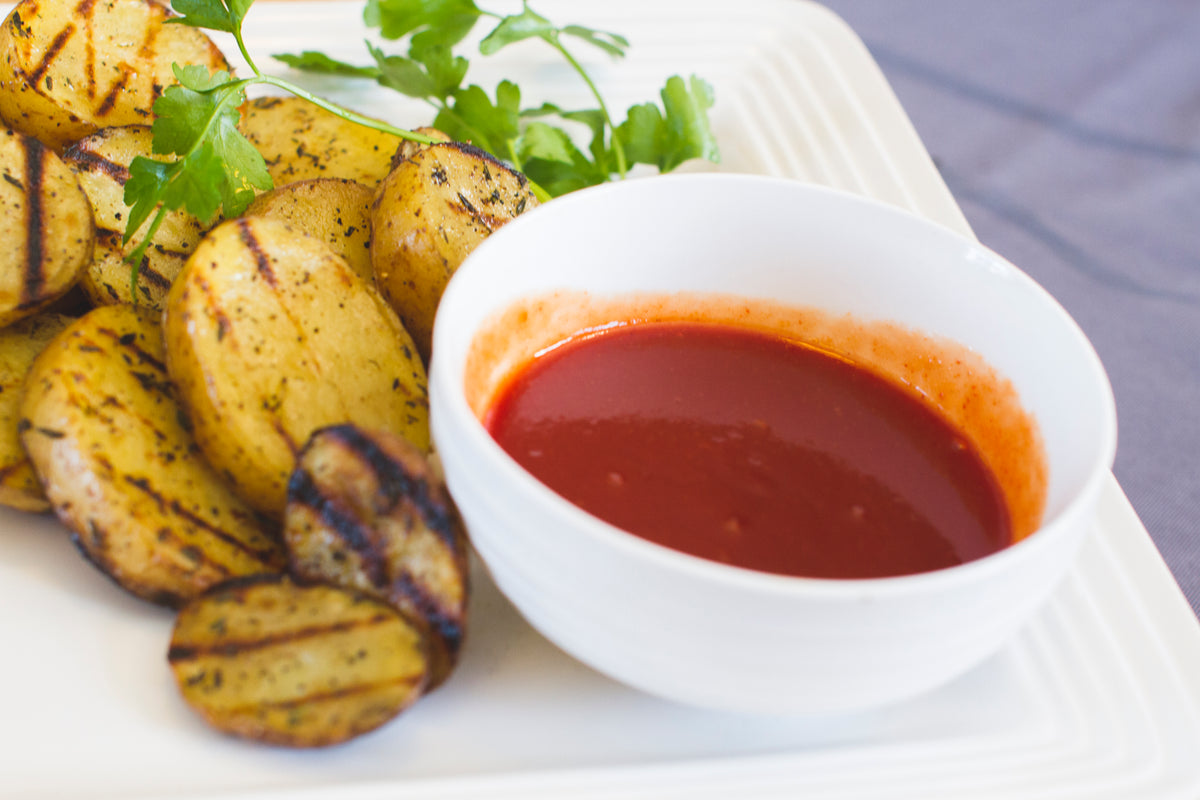CharBoy's Hot & Spicy Ketchup with grilled potatoes and a ramekin of ketchup